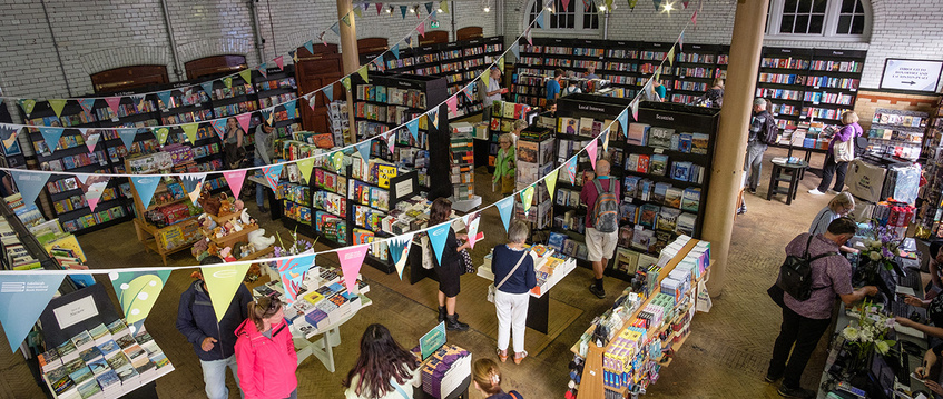 Bunting hangs above a busy bookshop